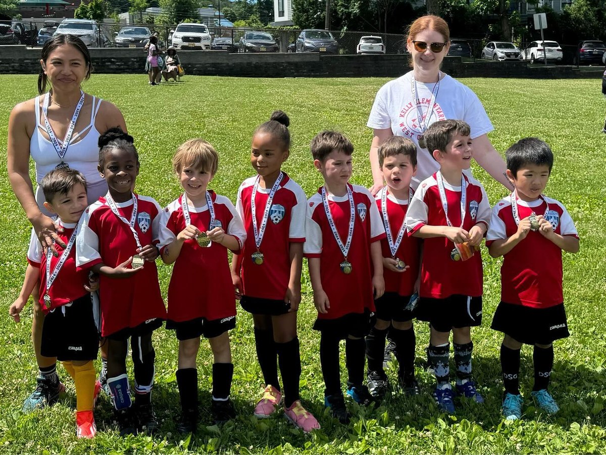 An MTL soccer team lined up on the field with their coaches after a game